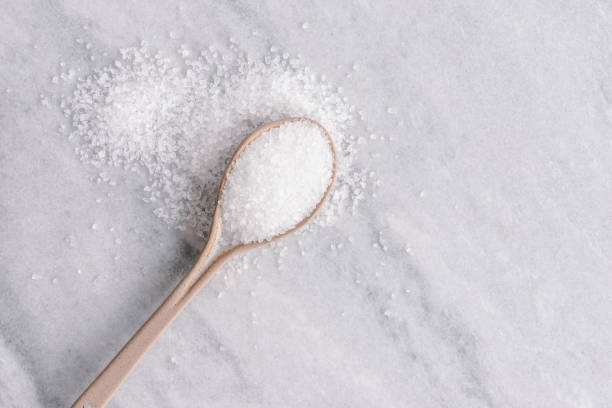 istock White crystal sugar on a ceramic spoon on a grey marble background 1406020509