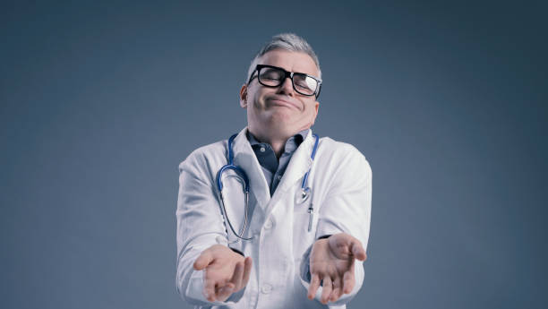 istock Funny clueless doctor shrugging and looking at camera 1406020573