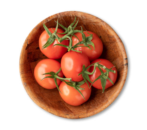 istock Red tomatoes in a bowl isolated over white background 1406020715