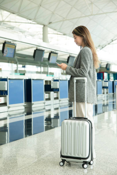 istock A young lady is waiting for check in at the counter 1406021105