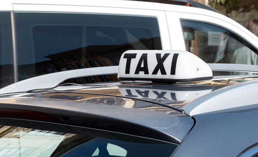 Simple traditional taxi cab car roof top sign, white object up close, detail, closeup, nobody, daytime Taxi service business, city transportation concept, no people, taxicab symbol, urban transport