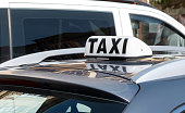 Simple traditional taxi cab car roof top sign, white object up close, detail, closeup, nobody, daytime Taxi service business, city transportation concept, no people, taxicab symbol, urban transport