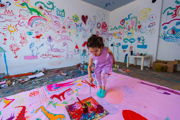 istock Girl in a painting action 1406021293