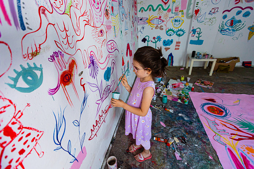 Little girl having fun in an art studio