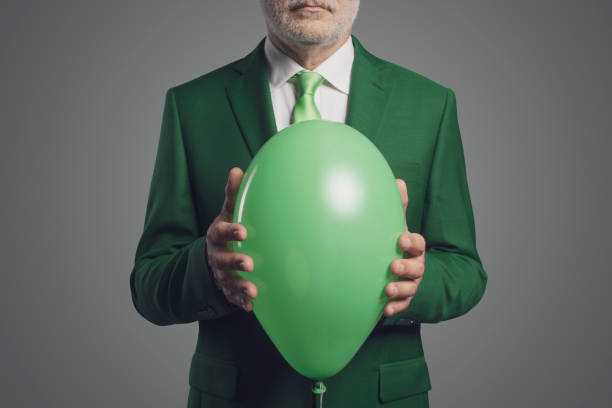 istock Corporate businessman holding a green balloon 1406022331