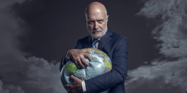 Greedy corporate businessman crushing and exploiting earth stock photo