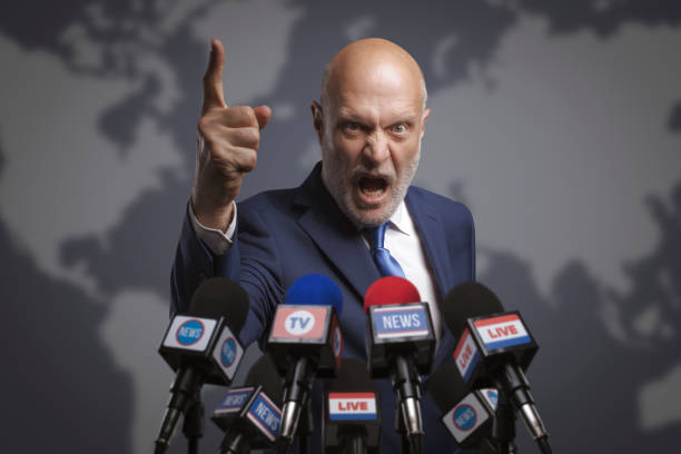 Angry leader interviewed by media stock photo
