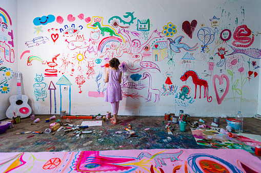 Girl drawing acrylic painting at home