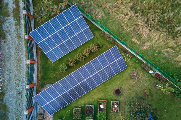 istock Solar photovoltaic panels mounted on stand-alone frame on backyard ground for generating of clean ecological electric energy. Concept of autonomous house 1406023940