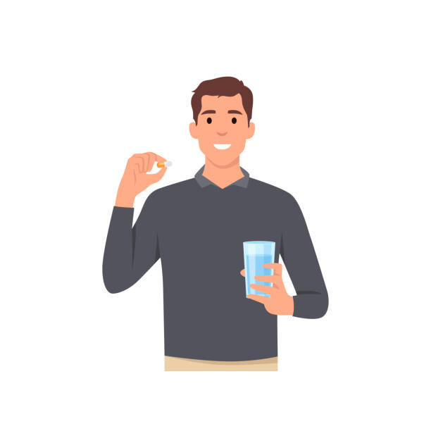 illustrations, cliparts, dessins animés et icônes de jeune homme dessin animé debout et tenant un verre d’eau et une capsule de pilule analgésique ou des médicaments vitaminiques dans les mains concept personnage - vitamin capsule illustrations