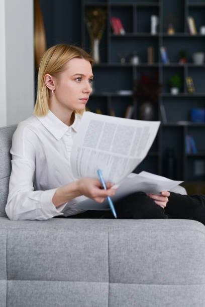 istock Woman sitting in office with papers 1406024493