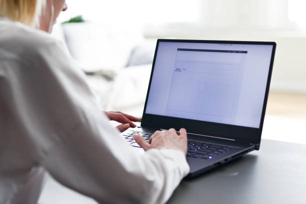 istock Laptop screen. Woman uses her notebook computer while sitting at desk 1406024548