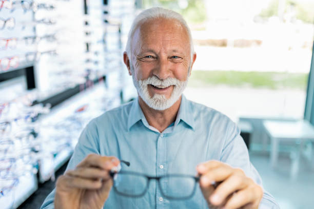 istock Senior man looking at camera trying new eyeglasses 1406024853