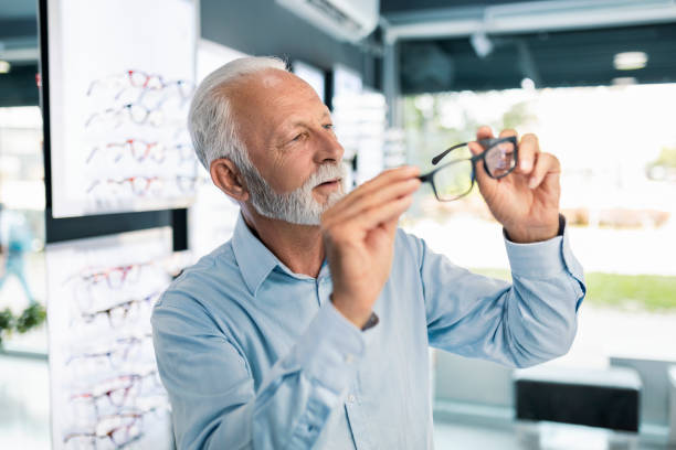 istock Senior man choosing eyeglasses to buy 1406024885