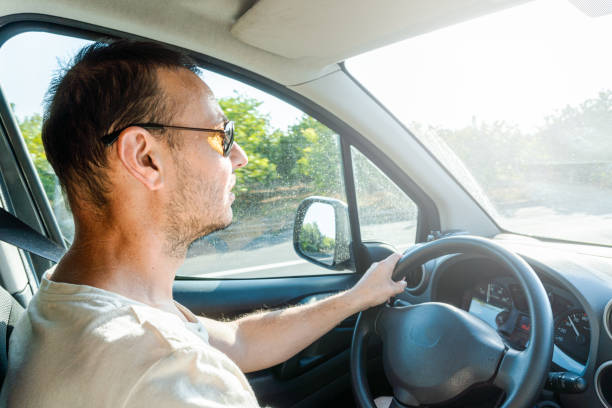 istock man driving sun face glare dazzled 1406025962