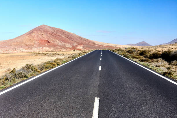 istock Empty highway asphalt road and mountain landscape 1406026534