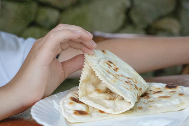 istock boy eating cheburek in a cafe 1406026548