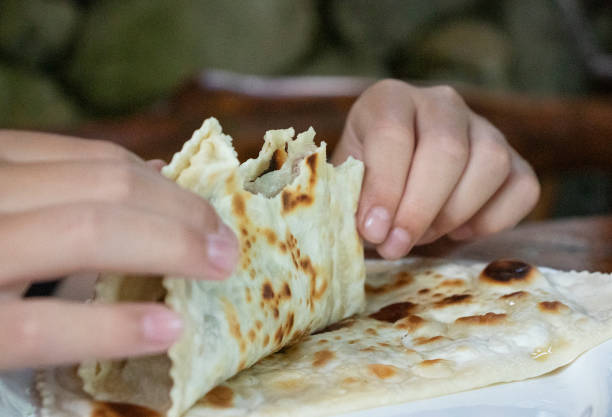 istock boy eating cheburek in a cafe 1406026639