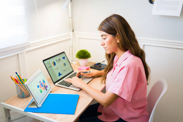 mujer hispana con mucho trabajo haciendo home office - working at home calendar laptop women fotografías e imágenes de stock