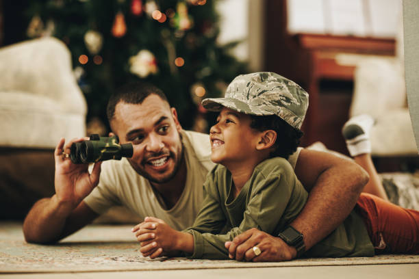 istock Happy military dad spending quality time with his son at Christmas 1406027887