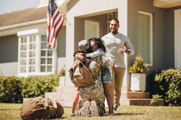 istock American servicewoman embracing her children on her return 1406028006