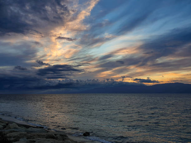 istock cloudy sky at sunset over the sea 1406028293