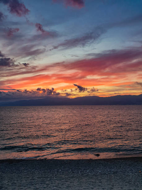 istock cloudy sky and red sunset on the sea 1406028325
