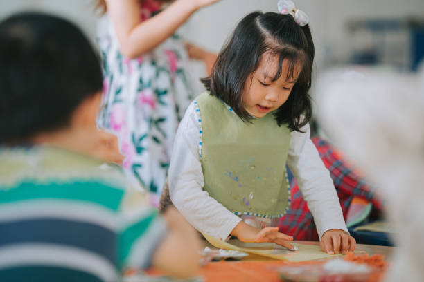istock asian Montessori preschool student enjoying drawing in classroom 1406029264