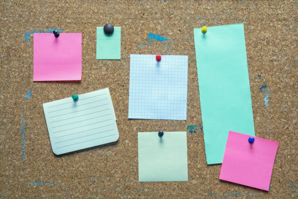 istock Colorful notes on old cork board. Free space for text or images 1406032943