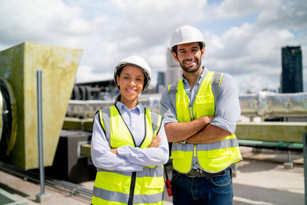 istock Portrait of two professional engineer or technician workers stand and look at camera with smiling and arm-crossed on terrace of construction site and day light. 1406033162