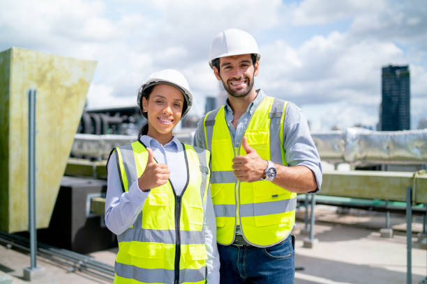 istock Portrait of two professional engineer or technician workers stand and look at camera with smiling and show thumbs up on terrace of construction site and day light. 1406033163