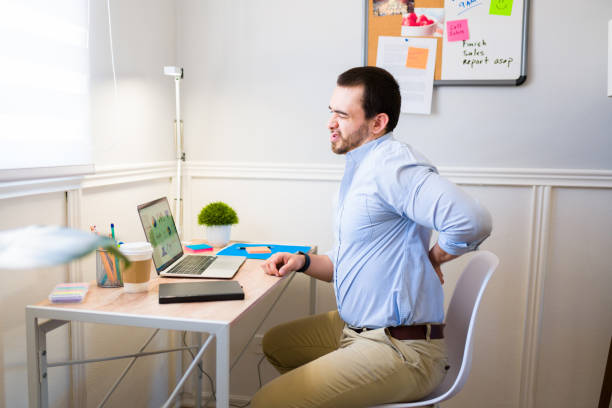 istock Stressed man with back pain finishing his remote work 1406033291
