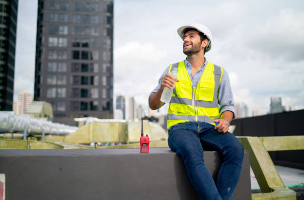 istock Caucasian professional engineer or technician sit on terrace of construction with relax after work and look around with happiness for success of the project. 1406033490