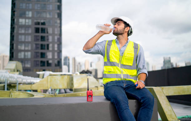 istock Professional engineer or technician worker man drink water from bottle and sit in area of terrace of construction site. 1406033491