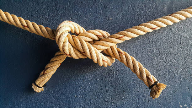tying ropes in a correlation pattern Ropes were tied together and hung on the blue wall correlation stock pictures, royalty-free photos & images