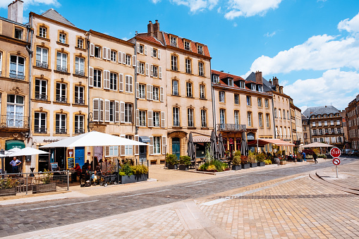 Cafes with customers sitting outside at Place de Chambre in the town of Metz in the Lorraine region of France.