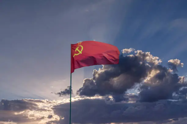 Photo of CCCP USSR Soviet Union flag waving in the dramatic cloudy sky