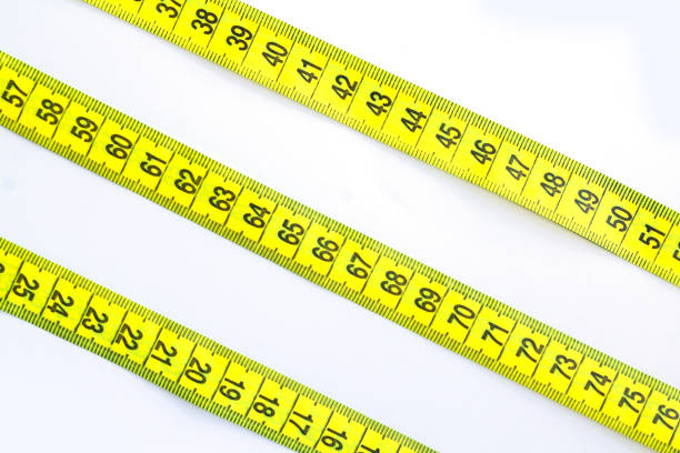 istock Yellow measuring tape or centimeter isolated on white background 1406041945