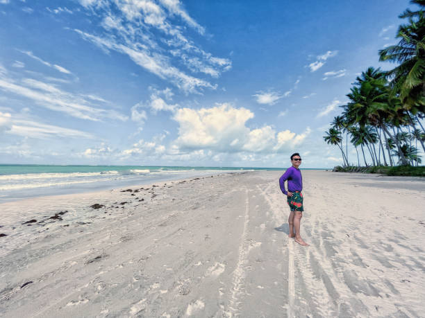 istock Man posing for photo on the beach. 1406044180