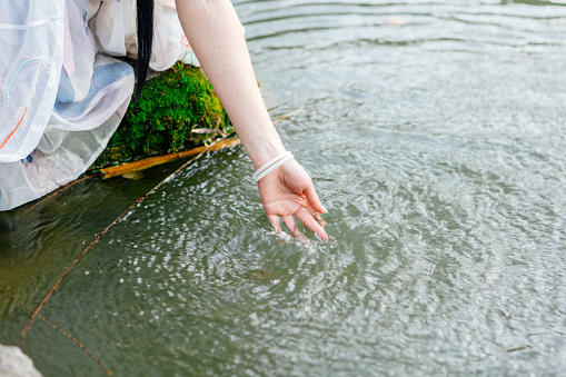 Cu hands playing with water