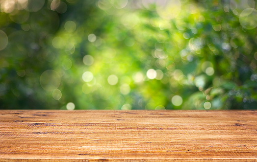 wooden table close-up outdoors. Abstract background with bokeh