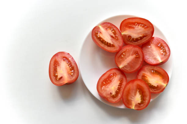 istock Sliced red tomato on a white plate 1406046289