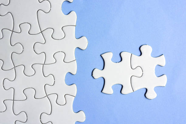 istock White puzzles and purple background. Concept of idea, discovery, difference, unique. Business concept. Copy space. Flat lay. 1406047535