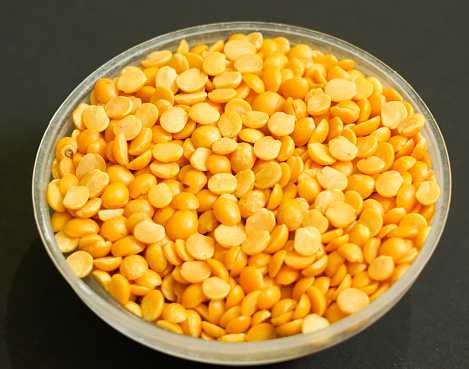 yellow toor dal for making dal tadka, Indian pulses isolated black background