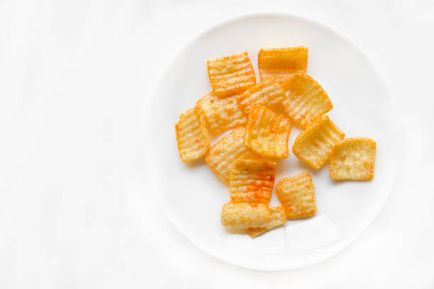 Pile of crispy triangle shaped snack isolated on white background