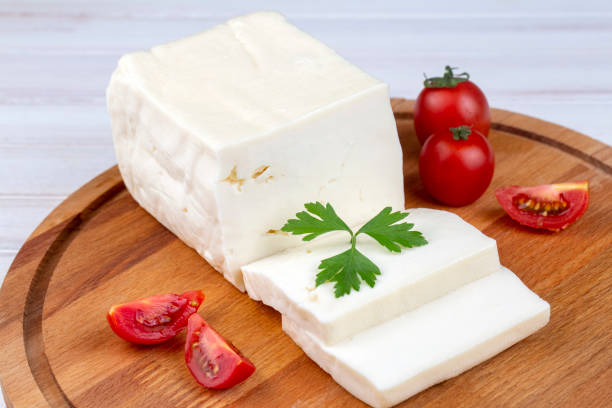 istock Feta greek turkish cheese on chopping board white background 1406054180