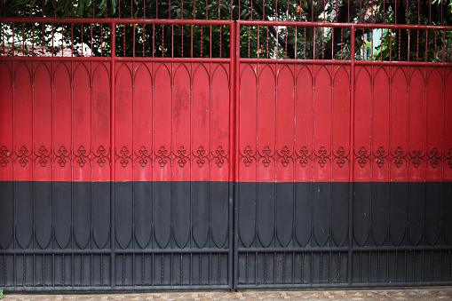 a driveway with a gray sliding gate in front of a beautiful house