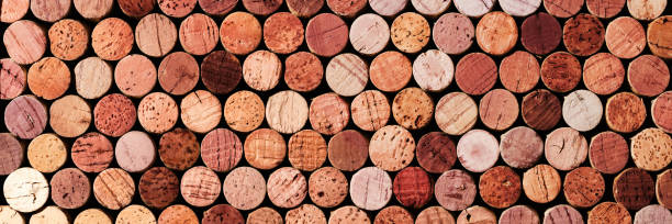 banner of wine cork from red wine, natural texture used bottle stoppers top view, red gradient. horizontal background from closeup wooden corks. natural textured stoppers colored wide banner - wine bottle wine wood bottle stopper imagens e fotografias de stock