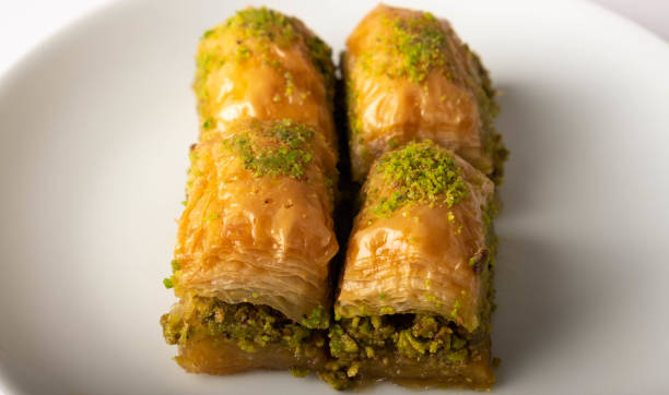 istock Turkish baklava with pistachio on a white plate (close up) 1406060114