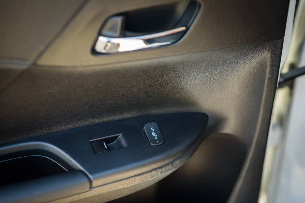 istock Car door control right rear panel. Leather new car interior. Car inside door chrome handle. Window lifter control. Armrest with seat heating adjustment button. Window open and close buttons. Door trim 1406063334
